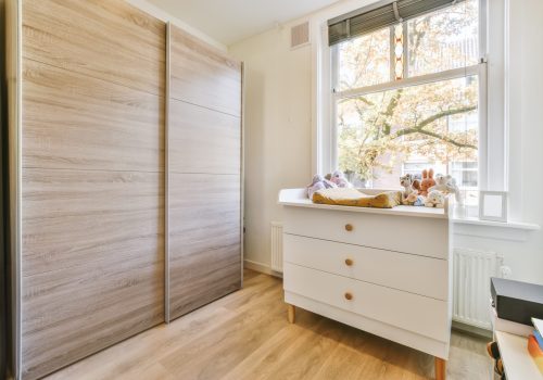 Adorable room with a window overlooking the street and a large wooden wardrobe